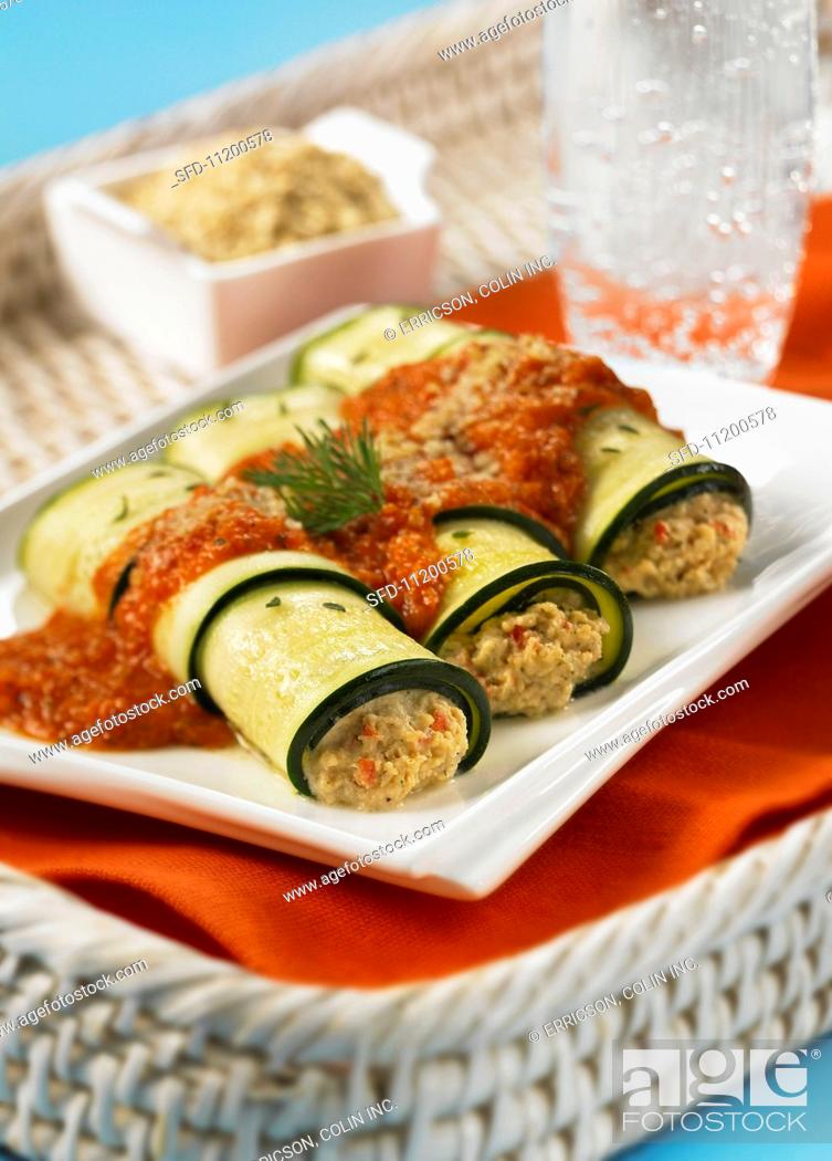 Stock Photo: Stuffed, rolled courgette slices with tomato sauce.