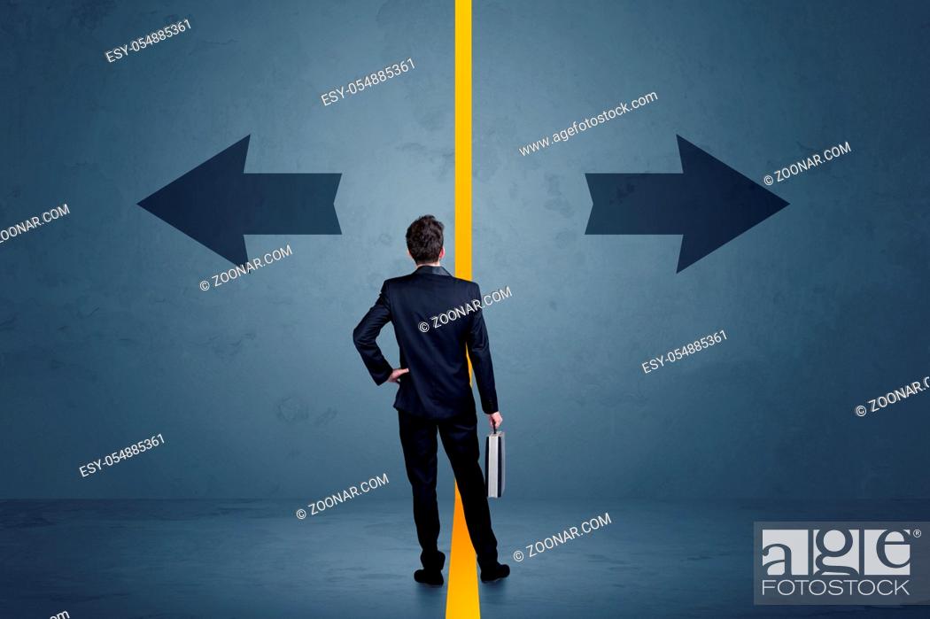 Stock Photo: Business person choosing between two options separated by a yellow border arrow concept.