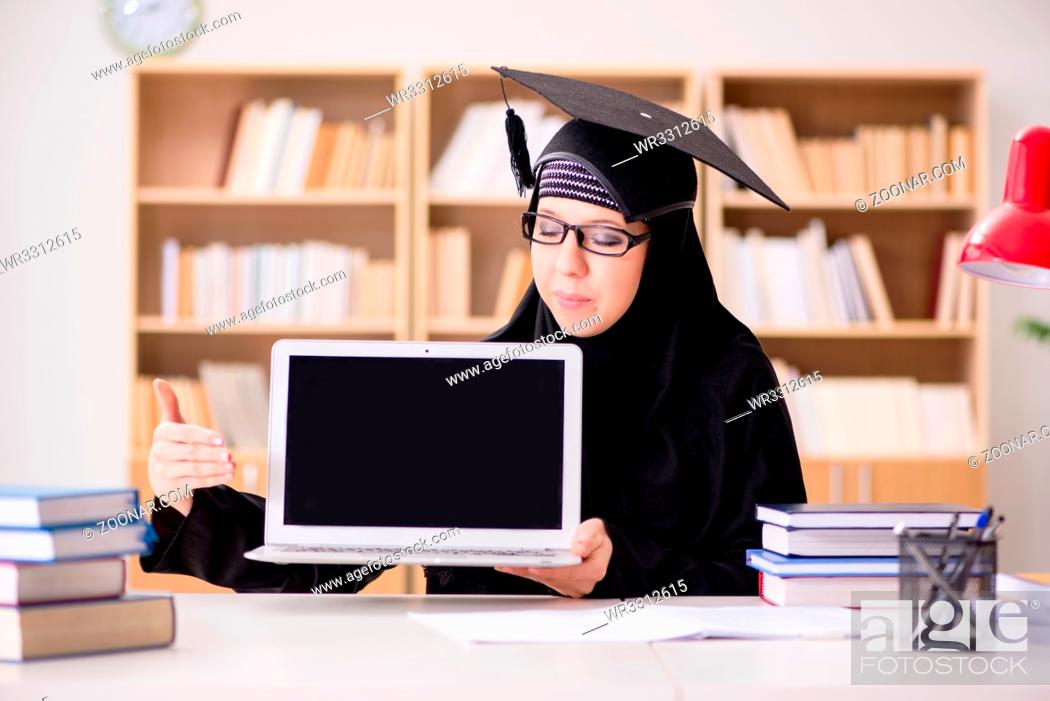 Stock Photo: Muslim girl in hijab studying preparing for exams.