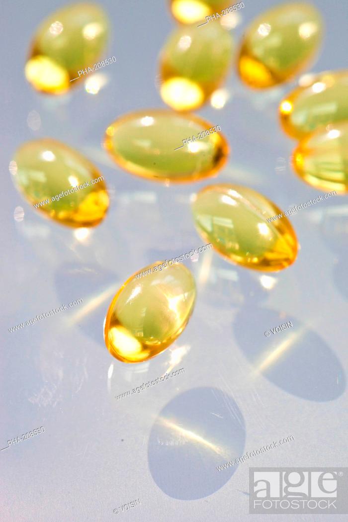 Stock Photo: Fish oil gelatine capsule and vitamin.