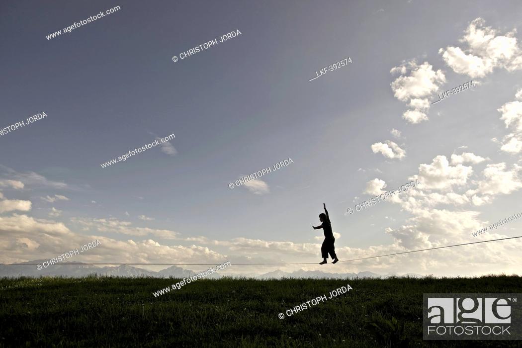 Stock Photo: Young man balancing on a longline, Auerberg, Bavaria, Germany, Europe.