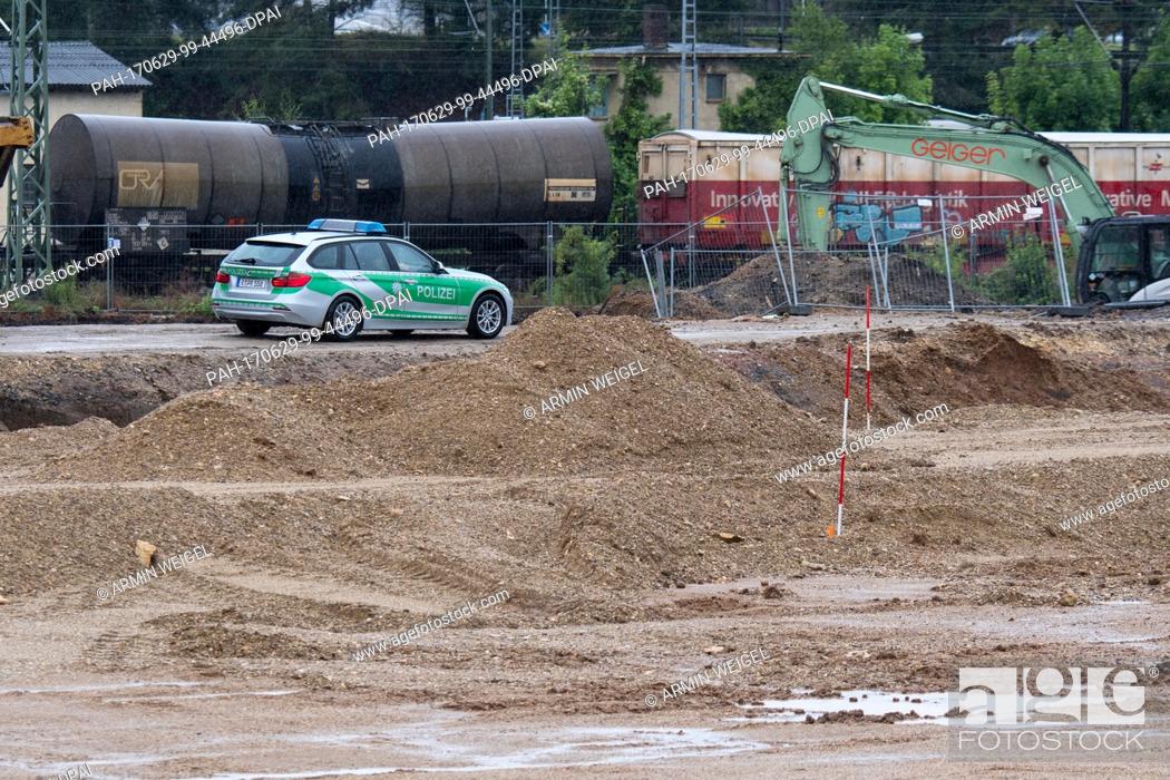 Stock Photo: A police vehicle drives through a construction site near to where an aircraft bomb was found in Regensburg, Germany, 29 June 2017.