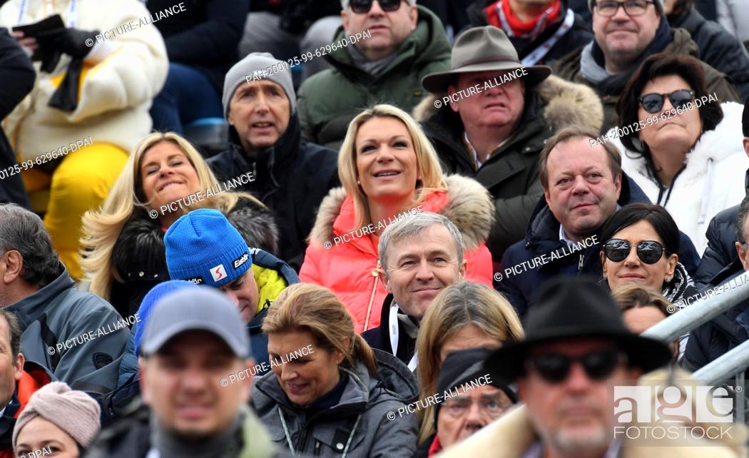 Stock Photo: 25 January 2020, Austria, Kitzbühel: Former ski racer Maria Höfl-Riesch (m) watches the men's downhill race on the Streif from the grandstand in the finish area.