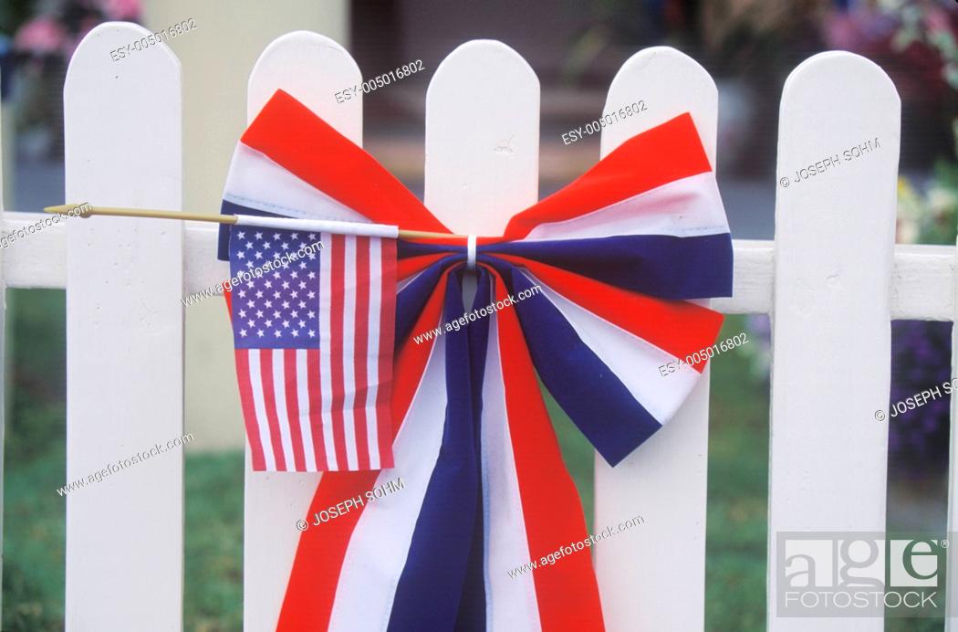Stock Photo: American Flag on White Picket Fence, Independence Day Parade, Cayucos, California.