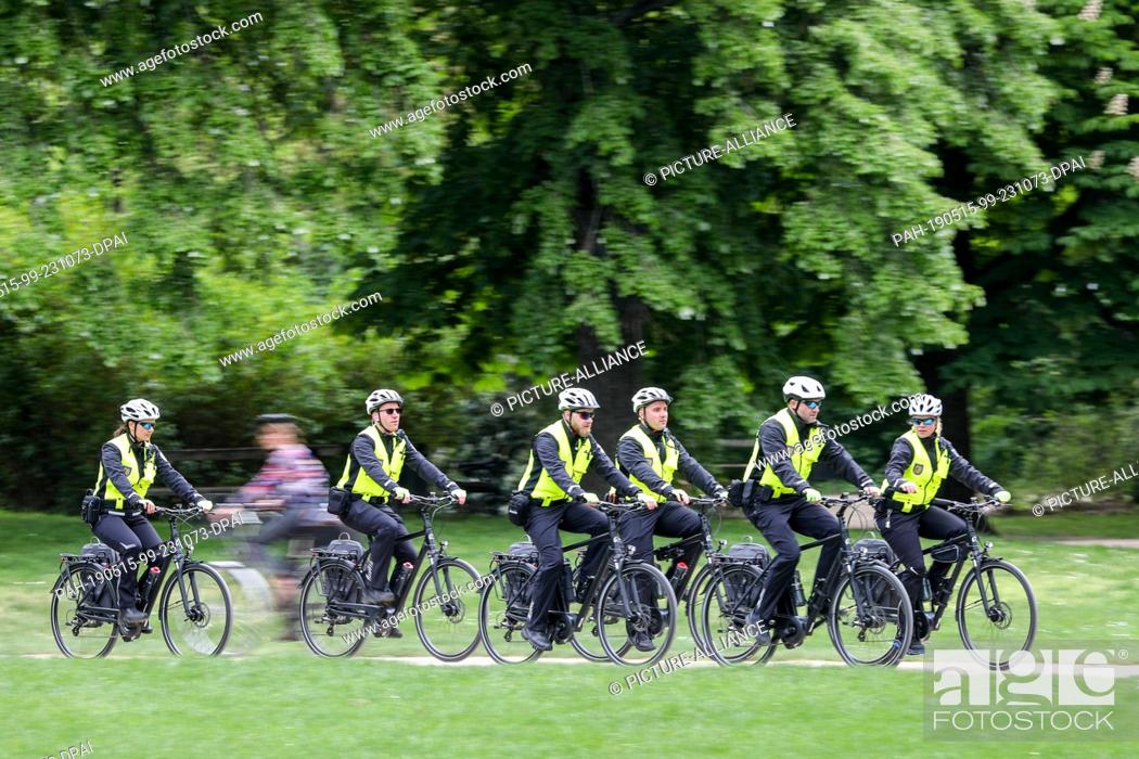 Stock Photo: 15 May 2019, Saxony, Leipzig: The new bicycle squadron of the Ordnungsamt Leipzig drives through the Johannapark. From now on.