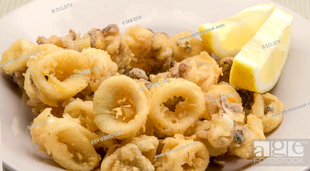 Stock Photo: Fried calamari rings served on a plate.