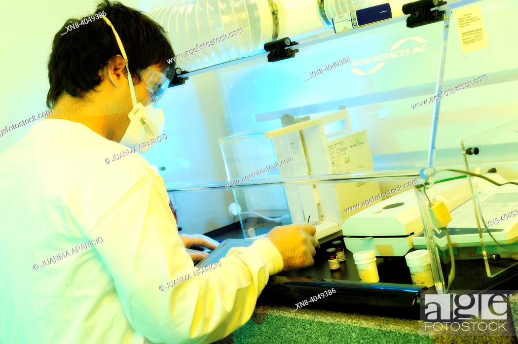 Stock Photo: picture of a scientist working in the lab performed with spectacular lights.