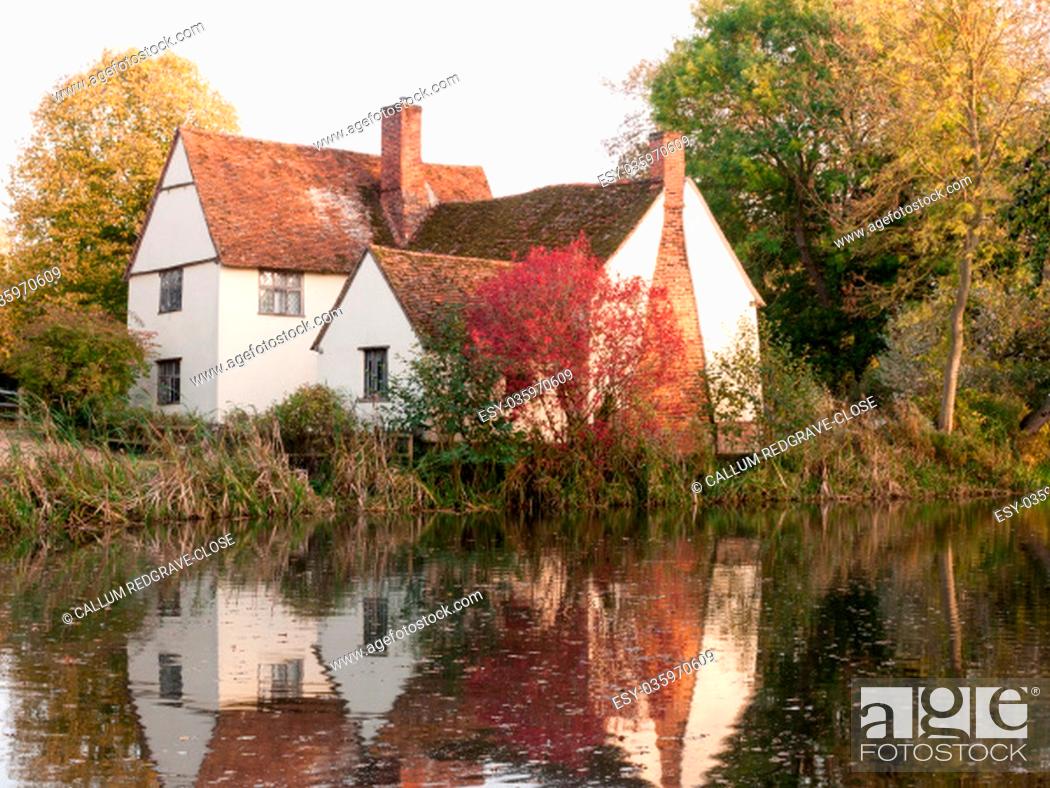 Stock Photo: willy lotts cottage at flatford mill in suffolk in autumn reflections in lake; suffolk; england; uk.