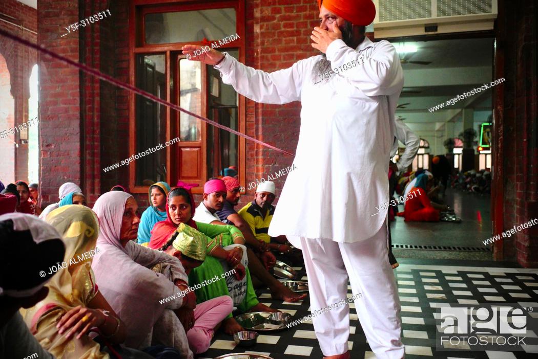Stock Photo: People waiting at the langar at Golden temple at Amritsar, where 60000 free meals are served everyday, and that mostly relies on volunteers to run it.