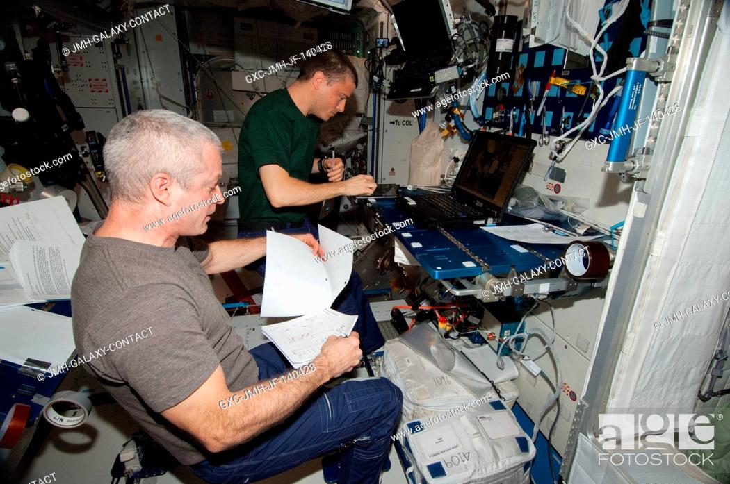 Stock Photo: In the International Space Station's Harmony node, NASA astronauts Steve Swanson (foreground), Expedition 40 commander; and Reid Wiseman, flight engineer.