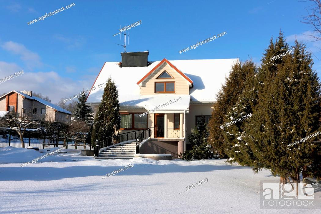 Stock Photo: VILNIUS, LITHUANIA - JANUARY 17, 2016: The uninhabited elite house and garden in the village of Buividiskes are brought by cold snow.