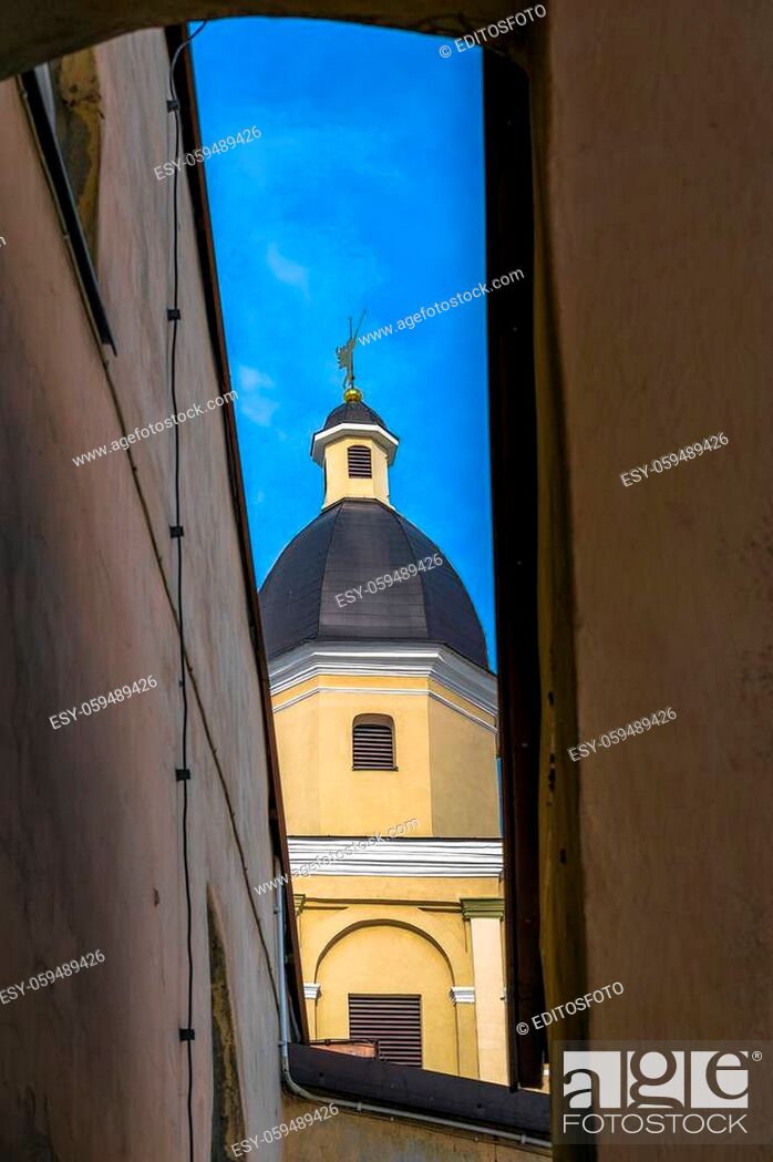 Stock Photo: The tower of the St Theresa's Church with an angel through the arch in the old town of Vilnius as seen from the Gate of Dawn, Lithuania.