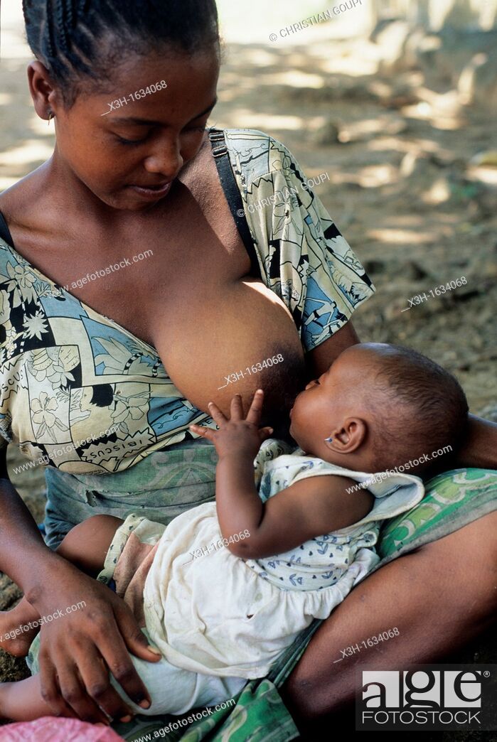Stock Photo: young woman breast-feeding her baby, Republic of Madagascar, Indian Ocean.