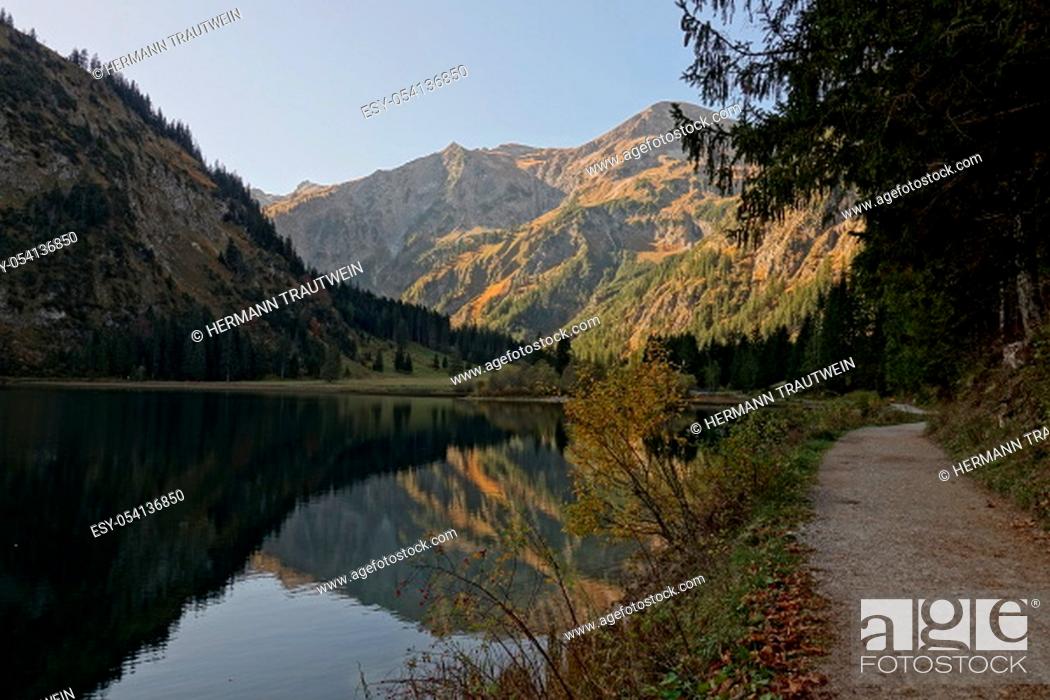 Stock Photo: The mountains in the Tannheimer Valley in Tyrol / Austria are reflected in the clear waters of the Vilsalpsee.