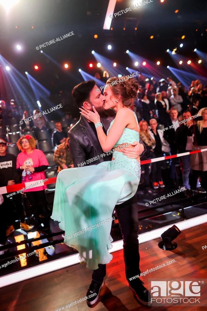 Stock Photo: 07 March 2020, North Rhine-Westphalia, Cologne: Laura Müller, TV personality, and her friend Michael Wendler, singer, hug each other after the RTL dance show.