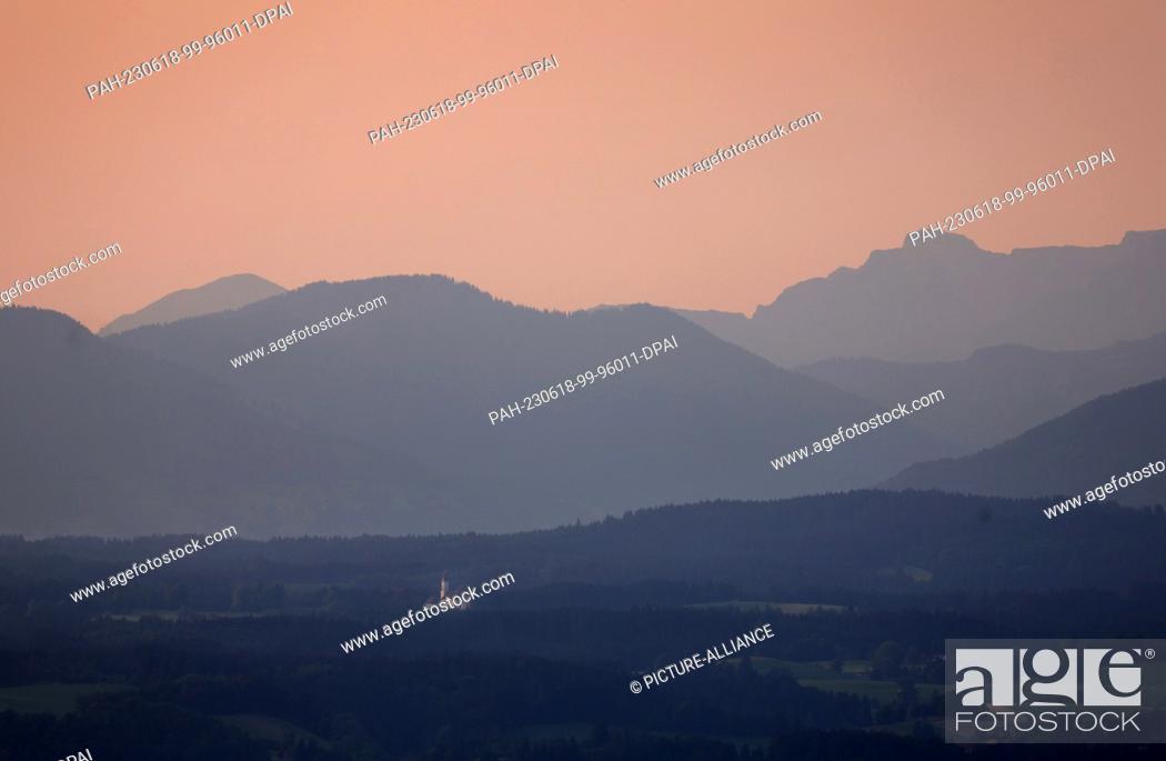 Stock Photo: dpatop - 18 June 2023, Bavaria, Steingaden: In the sunrise, the Wieskirche stands in front of the panorama of the Alps. Photo: Karl-Josef Hildenbrand/dpa.