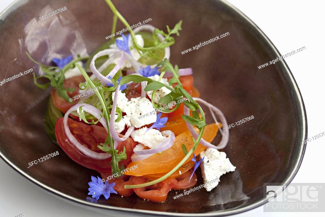 Stock Photo: Feta cheese tomato salad with wildflower.