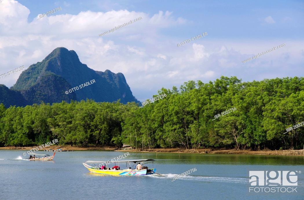 Stock Photo: Excursion boat on a river passing mangroves and limestone cliffs, Phang Nga, Thailand, Southeast Asia.