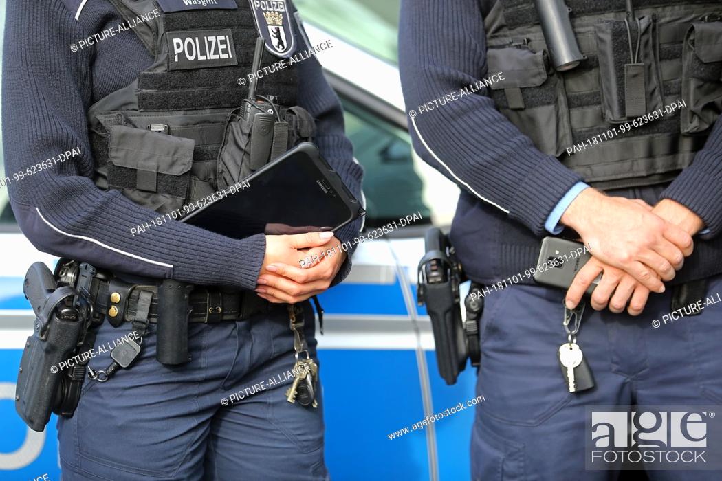 Stock Photo: 01 November 2018, Berlin: Section 34 police officers are holding new tablets and smartphones in their hands that were previously presented by the Interior.