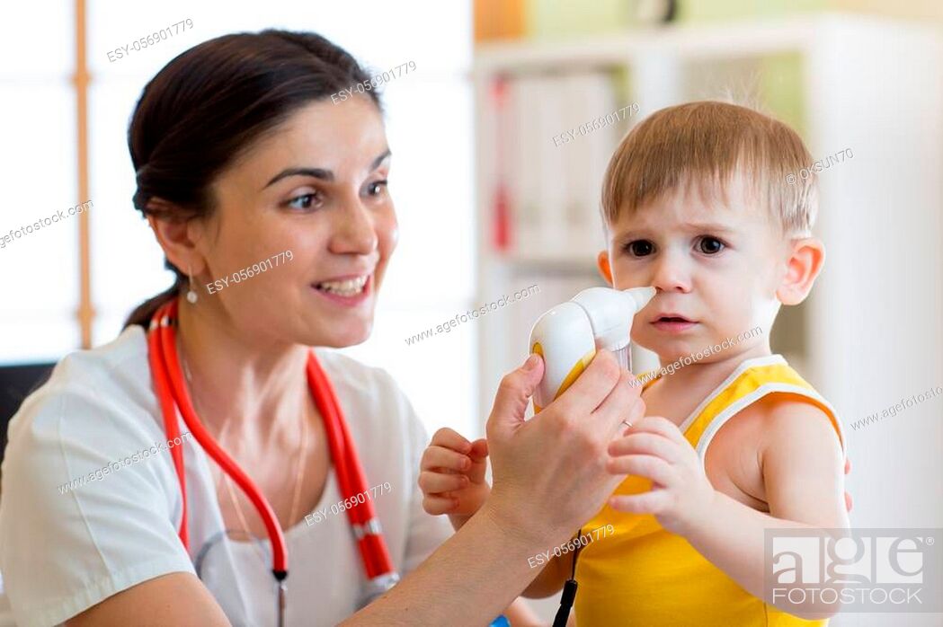 Stock Photo: Doctor helps to kid with runny nose.