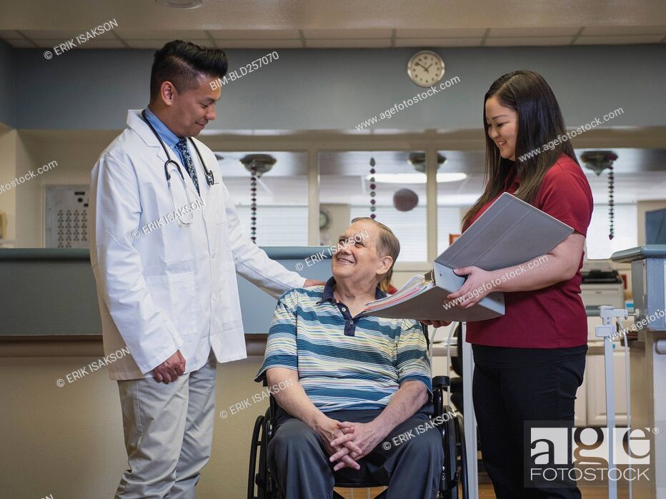 Stock Photo: Doctor comforting patient in wheelchair.