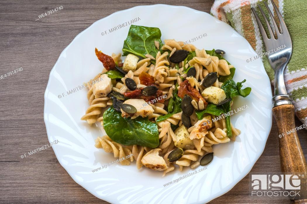 Stock Photo: Pasta salad on a plate on a table.