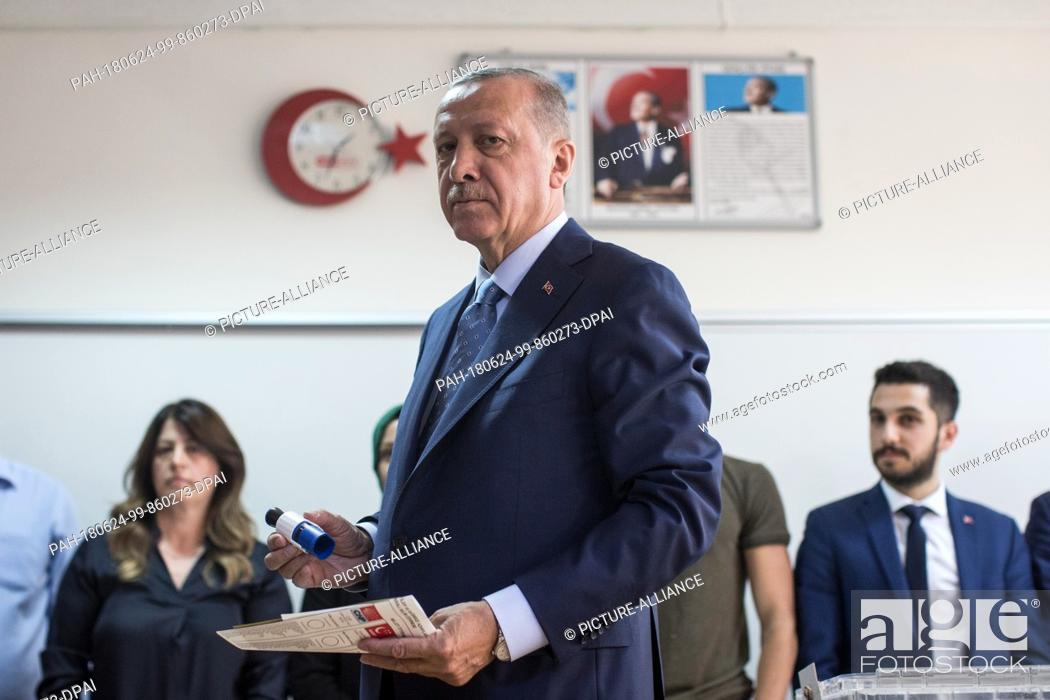Stock Photo: Turkish President Tayyip Recep Erdogan holds his ballot papers to vote in Turkey's elections at a polling station, in Istanbul, Turkey, 24 June 2018.