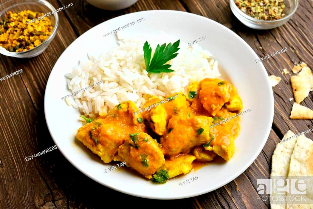 Photo de stock: Spicy chicken curry with rice on wooden table. Close up view.