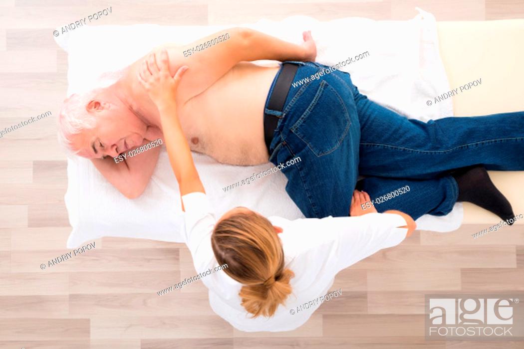 Imagen: High Angle View Of A Female Masseur Doing Massage On Senior Man.