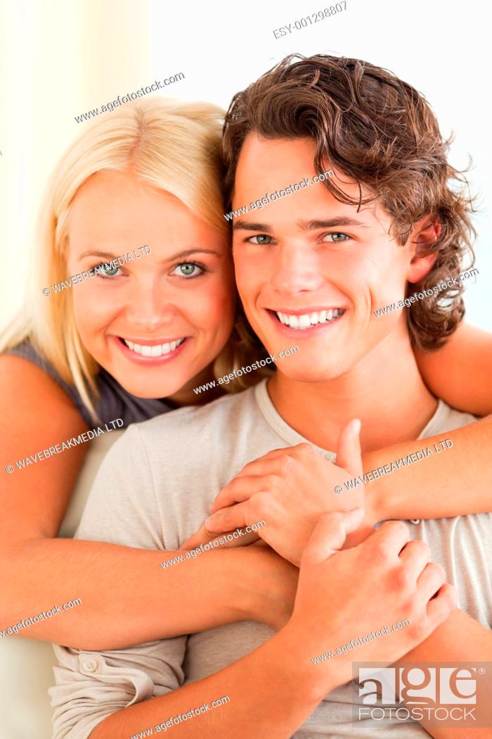 Stock Photo: Portrait of a happy couple embracing each other while looking at the camera.