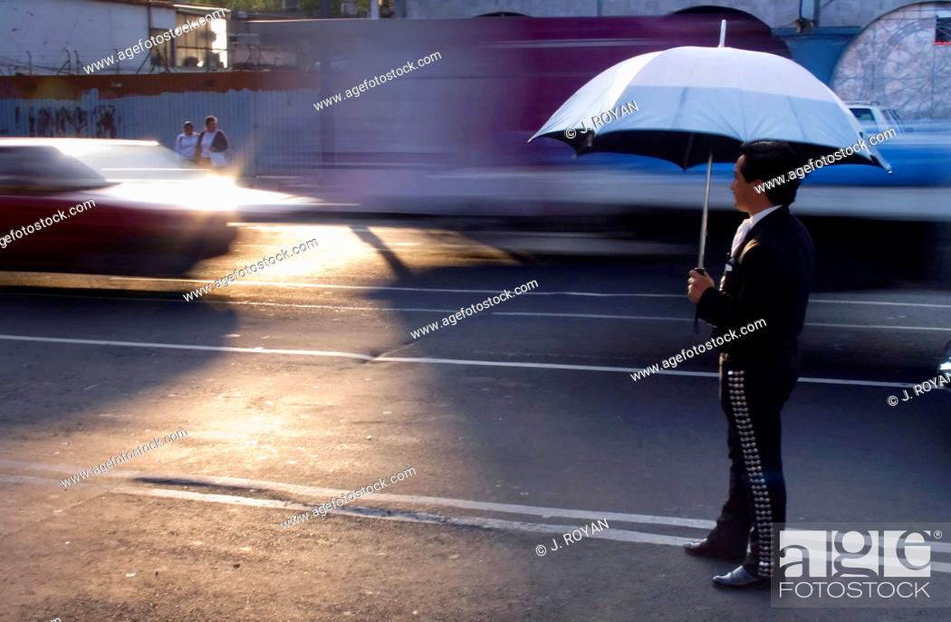 Stock Photo: A Mariachi waiting in a street for a car to stop and offer him a job. Mariachis in Plaza Garibaldi, Mejico, Mexico.