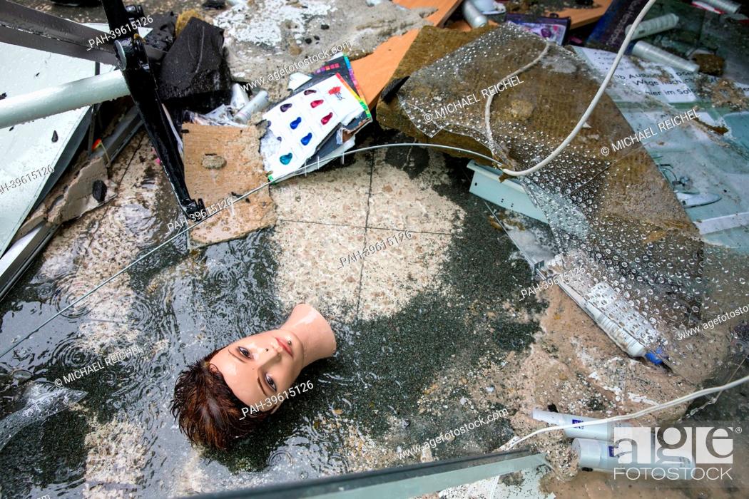 Stock Photo: The head of a mannequin of a hairdesser's salon lies on the floor between smashed pieces of glass at a shopping mall in Erfurt, Germany, 18 May 2013.