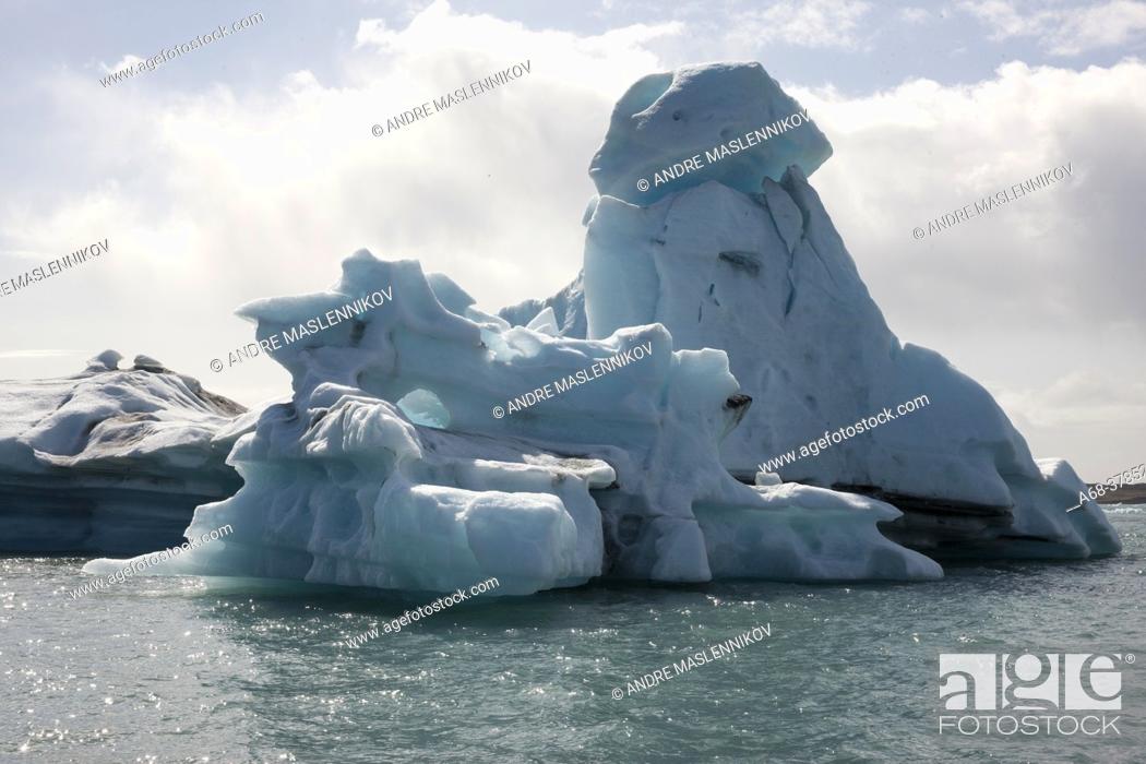 Stock Photo: Iceberg at Jökulsárlón on Breidamerkursandur. Thousands of people come here every day to see how the glacier tongue calves large icebergs.