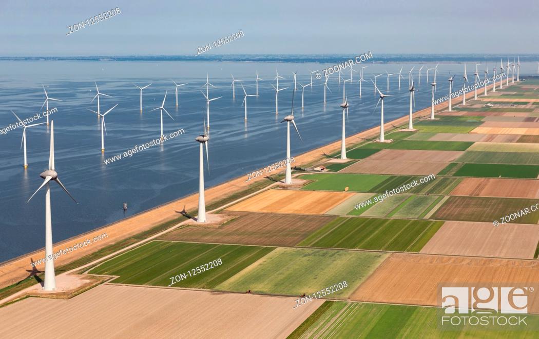 Stock Photo: Aerial view Dutch agricultural landscape with big offshore wind turbines along the coast.