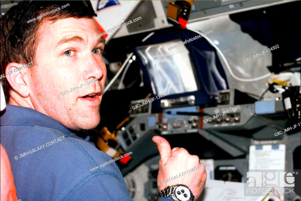 Stock Photo: Astronaut Rick D. Husband, pilot, signals with thumbs up during Discovery's rendezvous operations with the International Space Station (ISS).