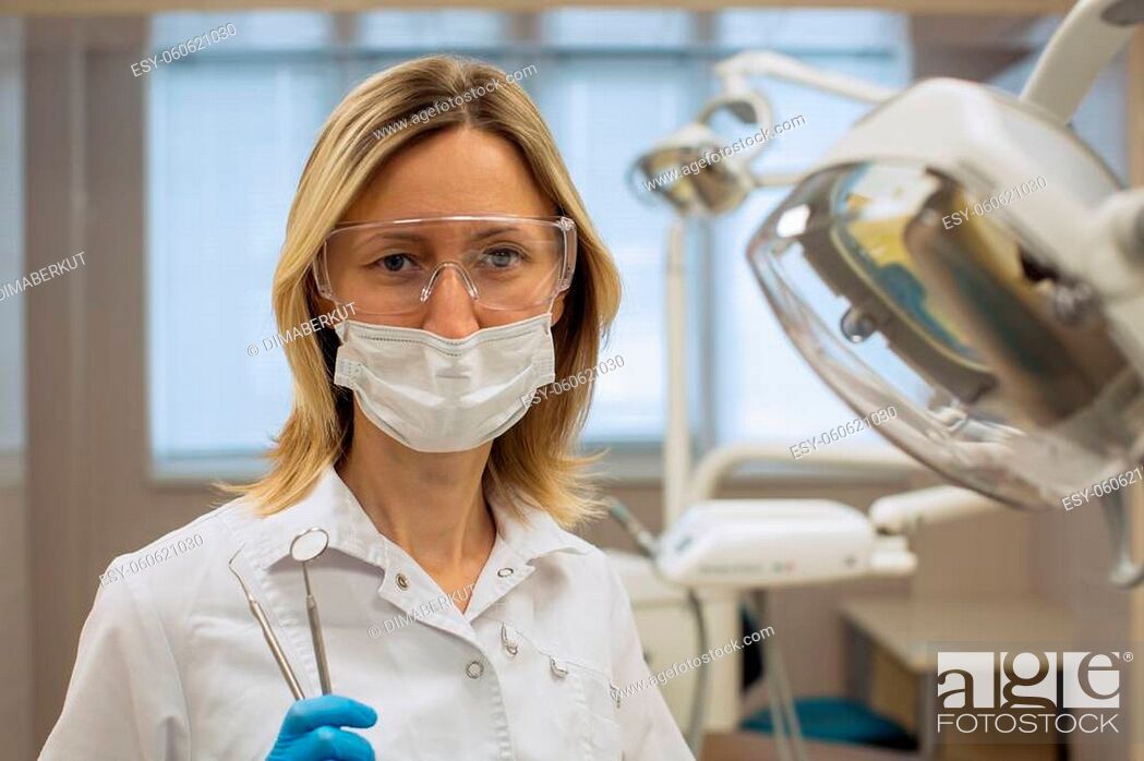 Stock Photo: Female dentist portrait with medical office background. Medicine and stomatology concept.