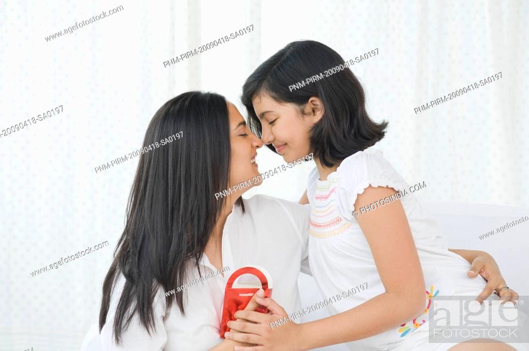 Stock Photo: Girl giving a present to her mother.