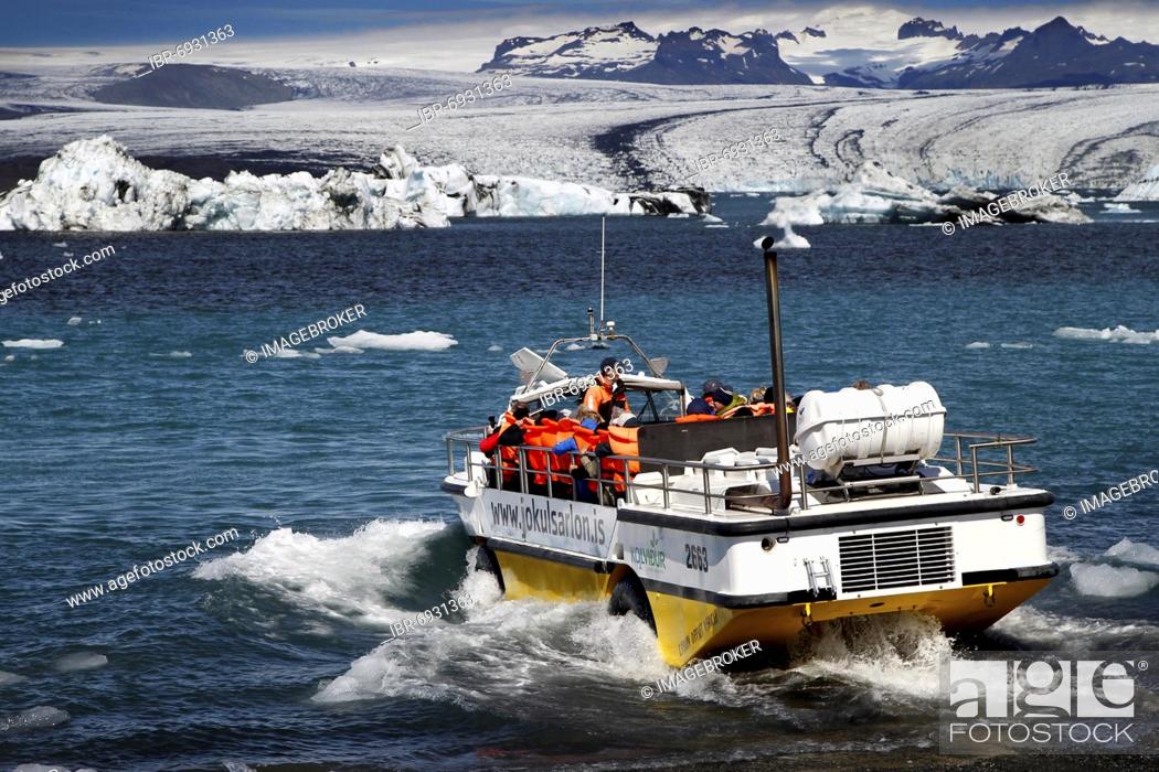 Stock Photo: Amphibious vehicle, boat with tourists, icebergs, floating ice chunks, glacial ice, glacier, calving glacier, glacier lagoon, glacier lake.