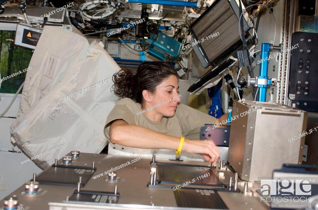 Stock Photo: NASA astronaut Nicole Stott, Expedition 21 flight engineer, installs hardware in the Fluids Integrated Rack (FIR) in the Destiny laboratory of the International.