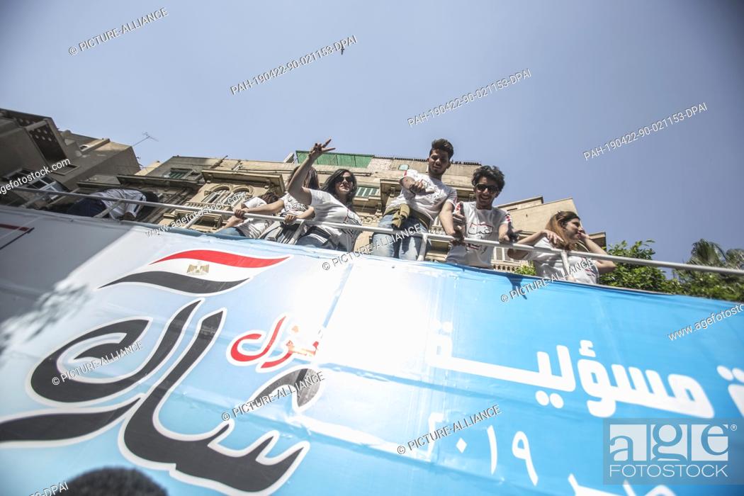 Stock Photo: 22 April 2019, Egypt, Cairo: Campaigners gesture on top of an open top campaign bus of the Mostaqbal Watan party on the third and last day of the national.