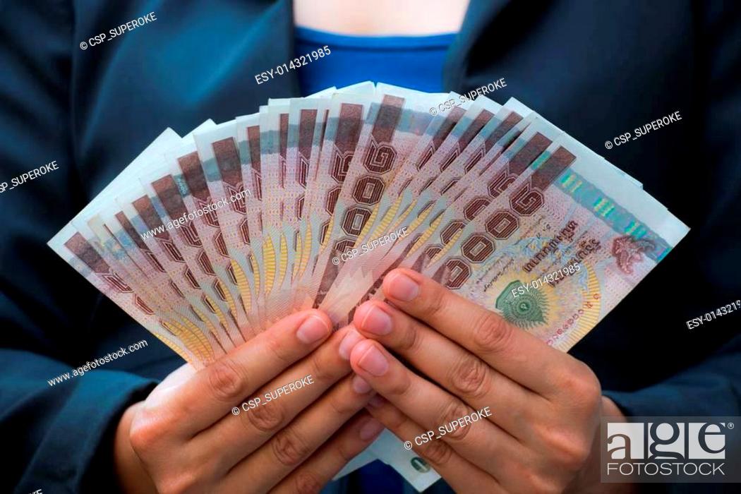 Stock Photo: business woman holding money.