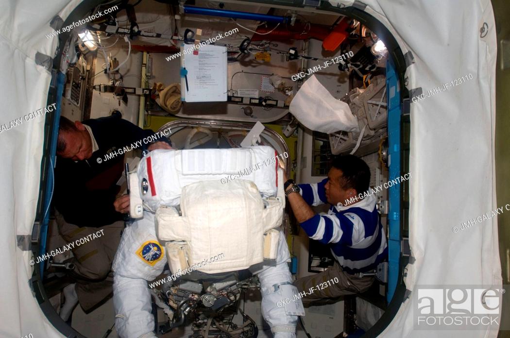 Stock Photo: Astronaut Steve Swanson, STS-119 mission specialist, attired in his Extravehicular Mobility Unit (EMU) spacesuit, prepares for the mission's second session of.