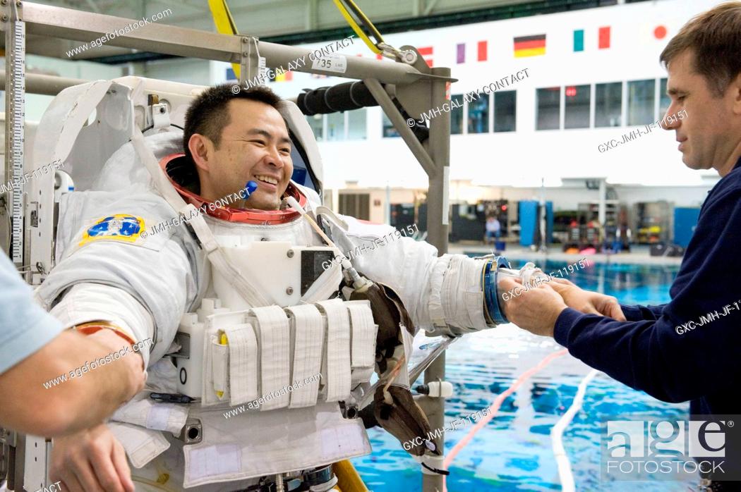 Stock Photo: Japan Aerospace Exploration Agency (JAXA) astronaut Akihiko Hoshide, Expedition 3233 flight engineer, dons a training version of his Extravehicular Mobility.