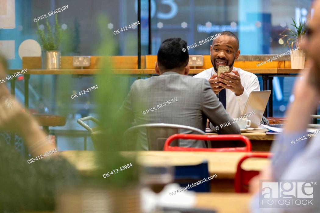 Stock Photo: Businessmen with smart phone working in cafe.