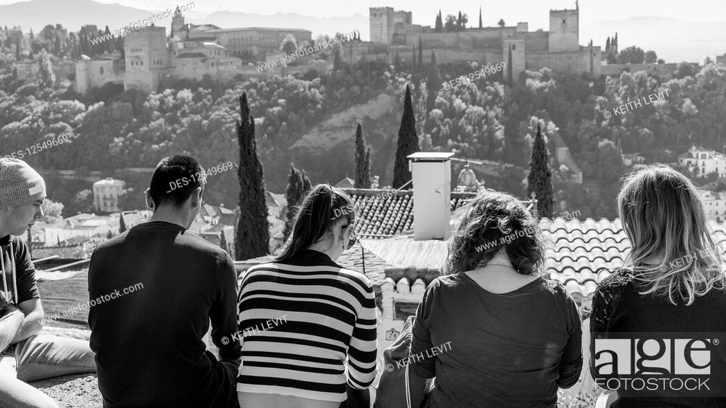 Stock Photo: Tourists sitting with a view of the Alhambra; Granada, Andalusia, Spain.