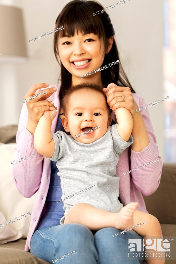 Stock Photo: happy young mother with little baby son at home.