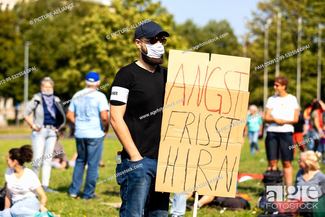 Stock Photo: 12 September 2020, Lower Saxony, Hanover: ""Fear eats brains"" can be read on the poster of a demonstrator at a demonstration against the Corona measures in the.