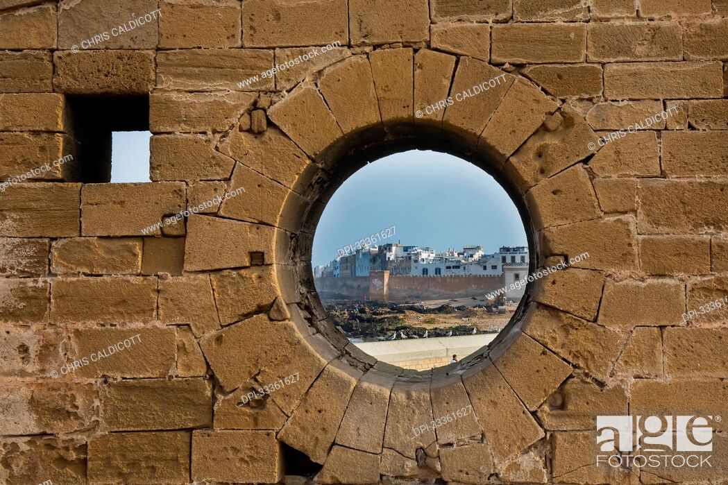 Stock Photo: Circular window in the wall of the Sqala du Port walkway to the Essaouira Citadel; Essaouira, Morocco.
