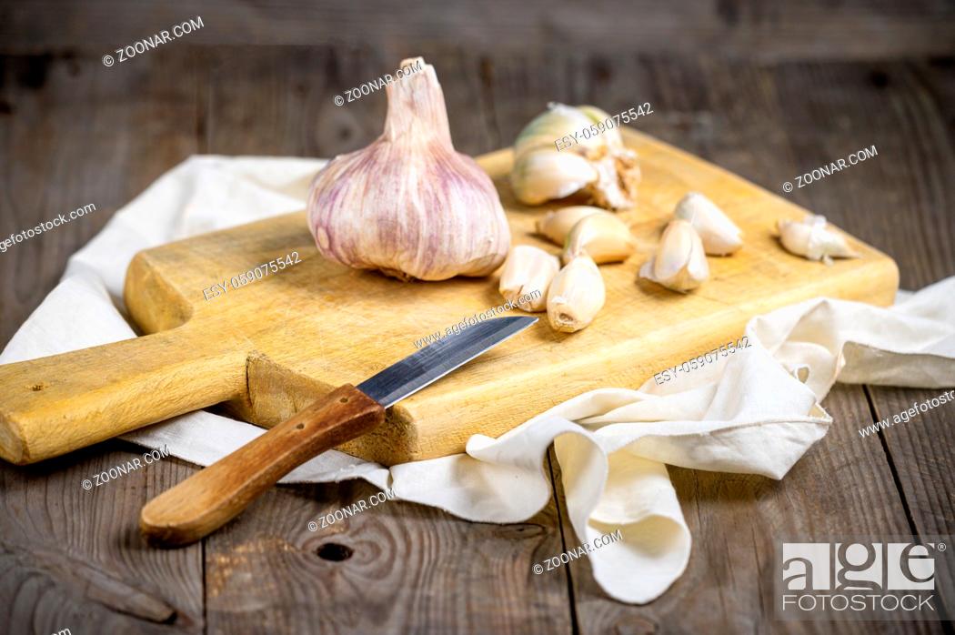 Stock Photo: Still life with garlics on rustic wood table .