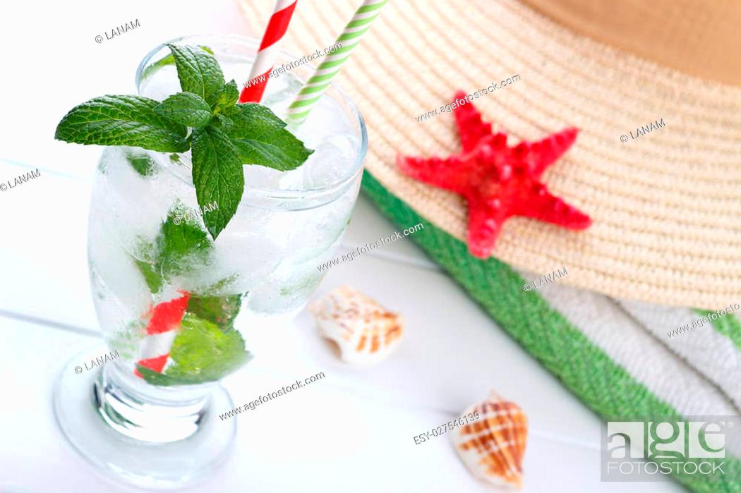 Stock Photo: Refreshing summer drink, fizzy water with ice and mint on white wooden board.